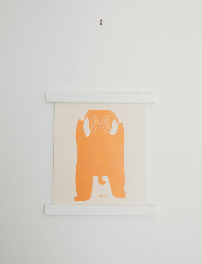 white and orange dog wall decor